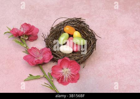 Easter nest, nest with sugar eggs and blossoms of the Japanese ornamental peach Stock Photo