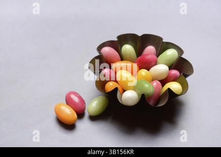 Colourful sugar eggs in baking tin, Easter Stock Photo