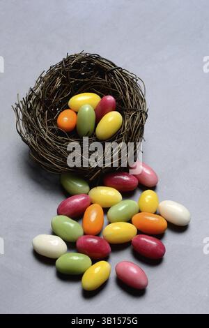 Colourful sugar eggs in nest, sugar Easter eggs, Easter festival Stock Photo