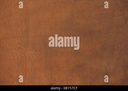 Genuine light brown leather texture. Calfskin leather surface with natural unique pattern, background, close-up, high resolution. Stock Photo