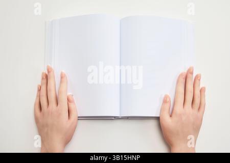 Open Blank Notebook. Hands holding an open blank notebook Stock Photo