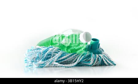 Plastic bottle with green disinfectant product for floors on mop with blue and white fibers on a clean and white reflective base and white isolated ba Stock Photo