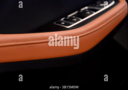 Luxury car interior with brown leather close-up. Car door close-up inside Stock Photo