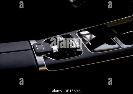 Selector automatic transmission with leather in the interior of a modern expensive car. Black and brown leather car. Modern automatic gearbox. Close u Stock Photo
