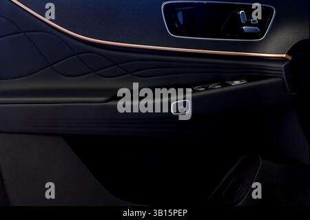 Interior of a modern car. Interior of a modern car. Close-up of a door handle, control buttons on a car door. Stock Photo