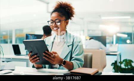 Tablet, research and businesswoman in office with web development, coding or design tools. Digital technology, reading and female programmer checking Stock Photo