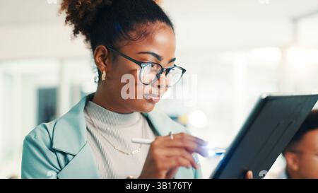 Programmer, woman and writing with tablet in office for coding, software update and web development. Programming, employee and testing digital app Stock Photo