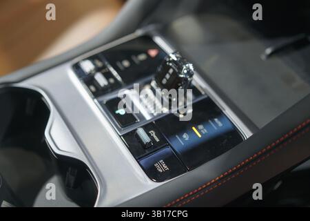 sleek center console displaying an automatic gear selector, start-stop button, and AC controls, showcasing user-friendly design and convenience. Stock Photo