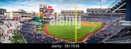 Nationals Park Baseball Game Washington DC | WASHINGTON DC — A high-resolution panoramic view of Nationals Park during a Washington Nationals baseball game in the early evening. The stadium, which opened in 2008 with a capacity of 41,339, serves as the home ballpark for the Washington Nationals Major League Baseball team. Located in the Navy Yard neighborhood along the Anacostia River, the stadium offers views of the Capitol and Washington Monument from certain sections. Stock Photo