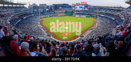 Nationals Park Baseball Game Washington DC | WASHINGTON DC — A high-resolution panoramic view of Nationals Park during a Washington Nationals baseball game in the early evening. The stadium, which opened in 2008 with a capacity of 41,339, serves as the home ballpark for the Washington Nationals Major League Baseball team. Located in the Navy Yard neighborhood along the Anacostia River, the stadium offers views of the Capitol and Washington Monument from certain sections. Stock Photo