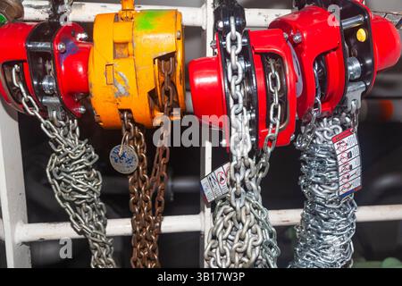 Chain hoists for lifting weights in a workshop close-up. Stock Photo