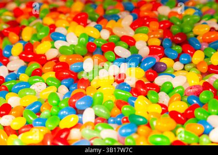Background from a pile of oval candies in multi-colored glaze. Stock Photo