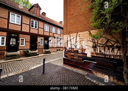 View of a griffito of container ships and port cranes on a brick house wall, showing the importance of the port and what it brings to Hamburg, Germany Stock Photo