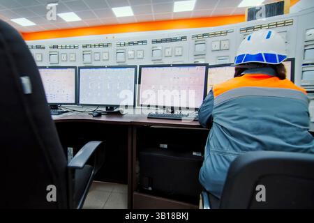 The control panel operator sits at the control panel and works. Stock Photo