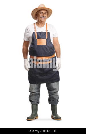 Mature gardener with a straw hat and rubber boots isolated on white background Stock Photo