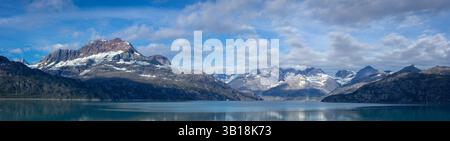 A stunning wide-angle horizontal panoramic landscape photograph capturing the raw, wild beauty of Glacier Bay National Park and Preserve in Alaska. Stock Photo