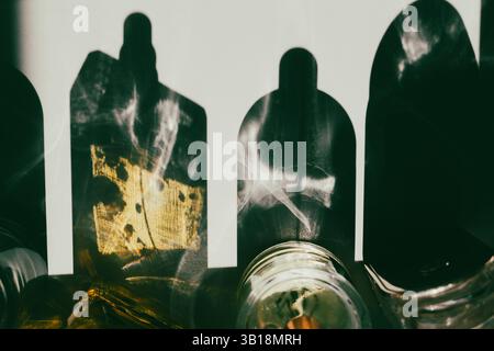 An overhead shot captures a play of light and shadow, created by glass objects casting abstract shapes on a surface. This adds a mystical atmosphere. Stock Photo