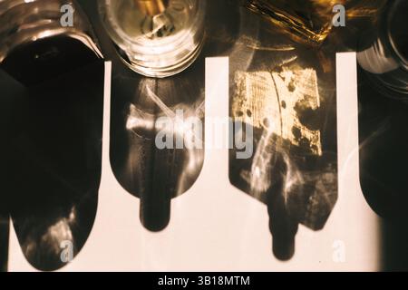 An overhead shot captures a play of light and shadow, created by glass objects casting abstract shapes on a surface. This adds a mystical atmosphere. Stock Photo