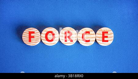 Force symbol. Concept word Force on beautiful wooden circles. Beautiful blue table blue background. Business lifestyle force concept. Copy space. Stock Photo