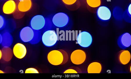 Multicolored Abstract Bokeh Lights Featuring Yellow Green Blue Red Orange Circles on Dark Festive Background Stock Photo