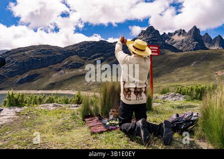 Andean man performing ritual of payment to the land in Peru, payment to ...
