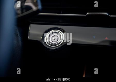 Car engine start button. Car interior. Car electronics. Modern cars. Start and stop. Start stop engine modern new car button. Stock Photo
