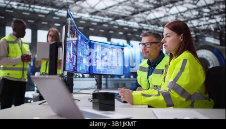 Skilled Black Engineer Operating Turbines In Power Plant Control Room. Stock Photo
