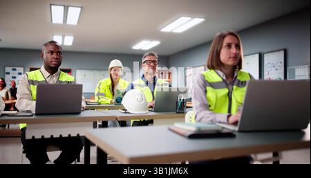 Students Work In A Classroom With Laptops, Learning Diverse Software. Stock Photo