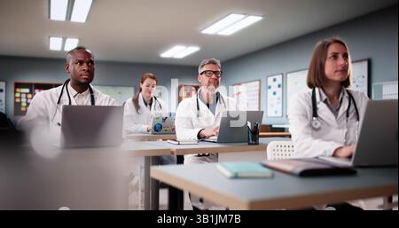 Diverse Group Of Medical Students Listen To Professor During Lecture. Stock Photo