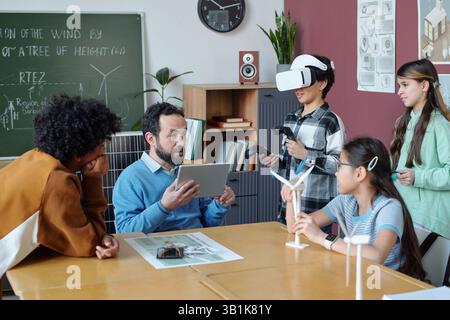Teacher Engaging Diverse Students in Virtual Reality Learning Stock Photo