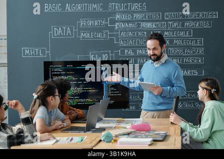 Teaching Programming Concepts in Classroom Setting Stock Photo