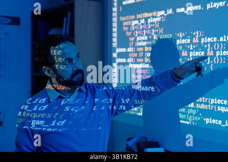 Software Developer Interacting with Projected Code Stock Photo