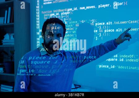 Engineer Creating Code with Projected Computer Screen Stock Photo