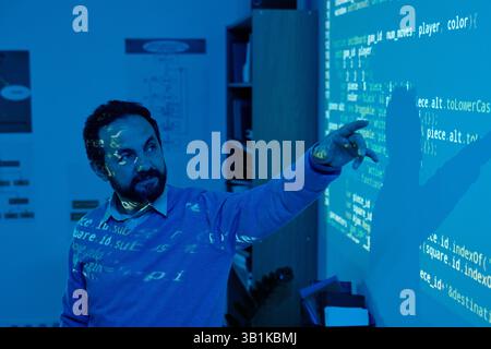 Man Interacting with Projected Screen Display in Office Stock Photo