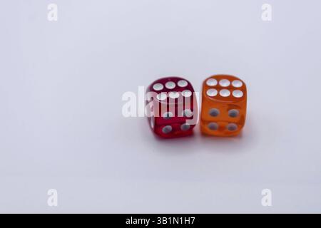 Two translucent dice in red and orange on a light background Stock Photo