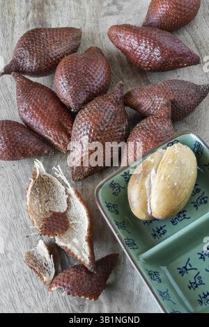 Snake fruit on a wooden board Stock Photo