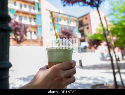 woman having iced matcha latte Stock Photo