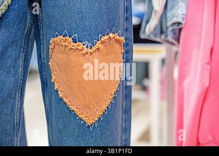 stylish jeans close-up with a patch in the form of a heart. Fashion and style Stock Photo