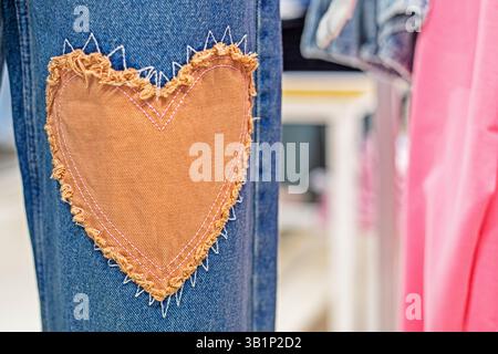 stylish jeans close-up with a patch in the form of a heart. Fashion and style Stock Photo