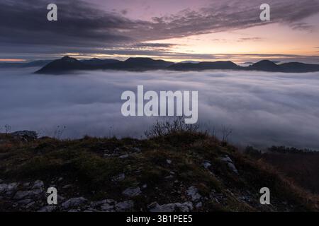 Dramatic autumn sunrise in mountain with red sky and clouds Stock Photo