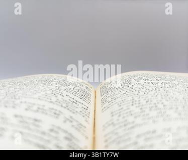 Old open book with yellow pages shot in macro on white background top view. High quality photo Stock Photo