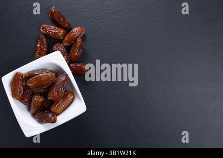 dates. dried fruits in white bowl. top view Stock Photo