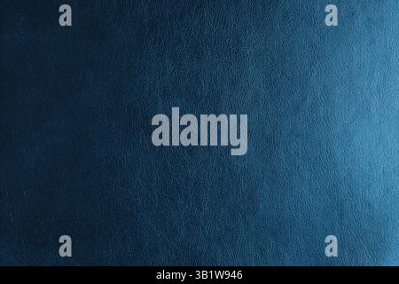 Glossy structure of genuine leather with gradient lighting effect, natural skin surface with embossing pattern. Artifical blue colored leatharette mac Stock Photo