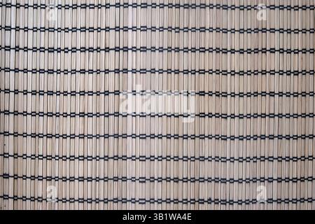 Natural bamboo mat with black thread grid pattern. Seamless woven texture background. Eco-friendly material. Interior and textile design concept for w Stock Photo