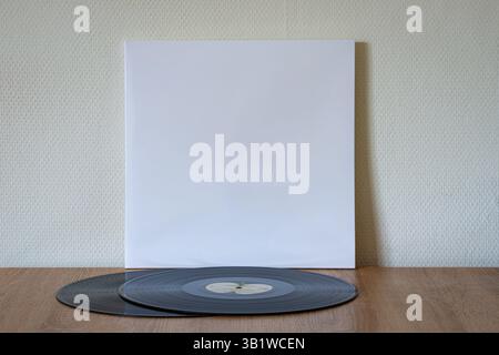 Legendary white record album called ¨The Beatles¨ by the band of the same name with two discs on a wooden table. Stock Photo