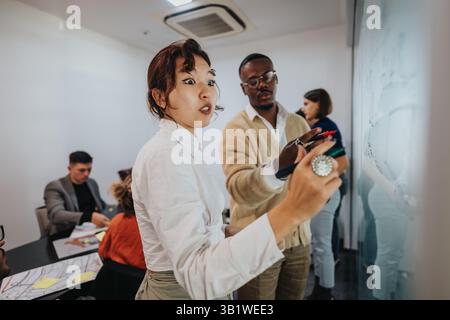 Multicultural team brainstorming and discussing project in modern office Stock Photo