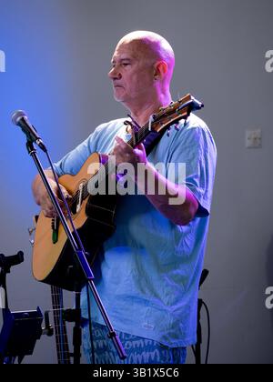 Folk musician playing an acoustic guitar, UK Stock Photo