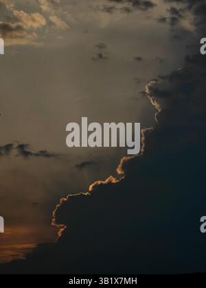 Sunlit Storm: Sunset Drama in the Sky Stock Photo