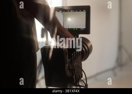 Production Crew Holding Camera during Video Shoot Stock Photo