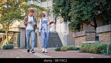 College students, walking and outdoor on campus for conversation, talk and share knowledge on module. People, friends and outside for project Stock Photo